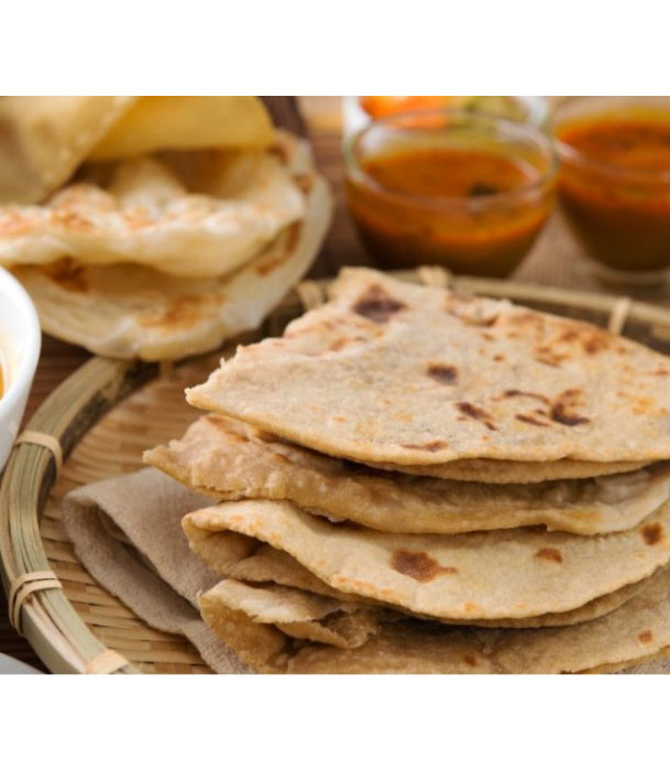 Stack of warm rotis with accompaniments